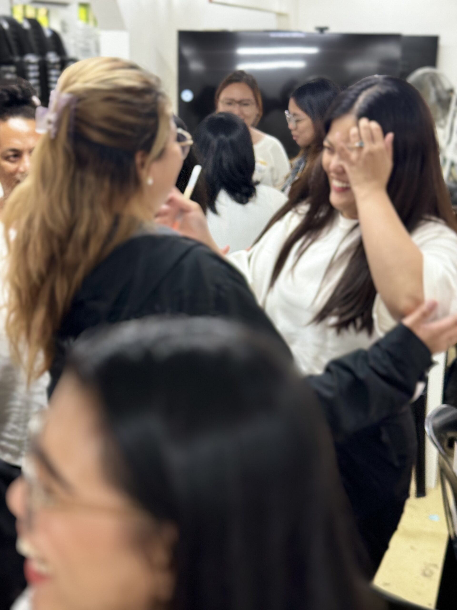 A TrainStation facilitator pointing at an interactive slide while leading an engagement activity with remote participants on a screen.